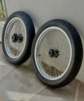 Surge Racing Supermoto Wheel Set for Talaria Bikes displayed side by side on a surface.