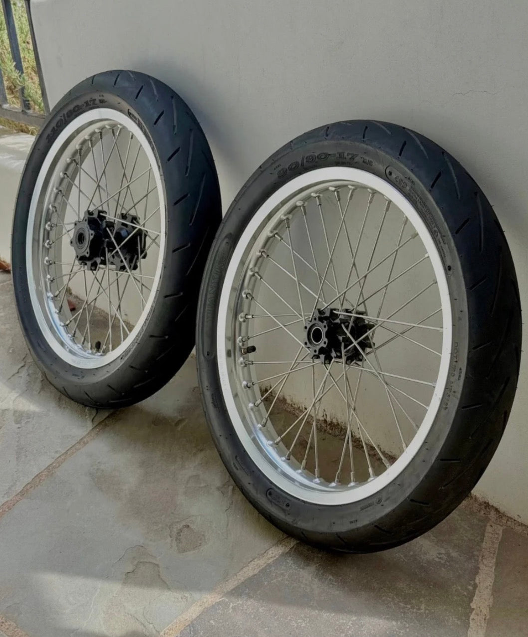 Surge Racing Supermoto Wheel Set for Talaria Bikes displayed side by side on a surface.